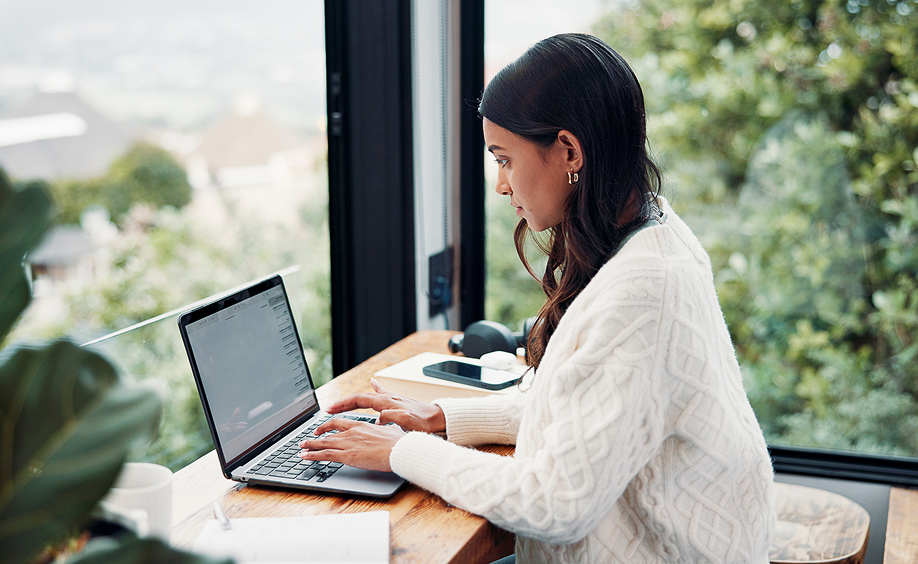 Woman working in open space surrounded by windows