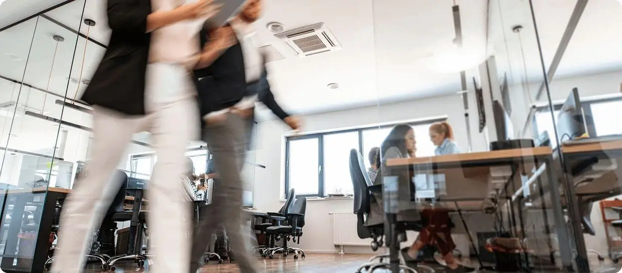 Employees collaborating in a modern office environment.